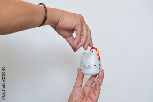 A man's hand holding a timer photo