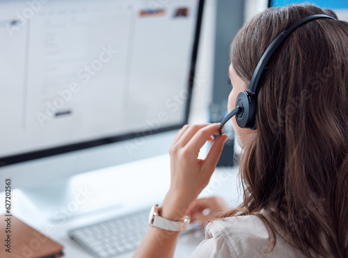 Customer support, call center and back of female agent working on online consultation in the office. Telemarketing, communication and saleswoman planning crm with headset and computer in workplace. photo