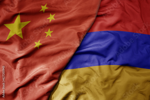 big waving national colorful flag of china and national flag of armenia .