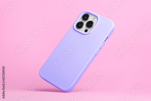 smart phone in purple soft silicone case falls down back view, iPhone 15 and 14 Pro Max case mockup isolated on pink background