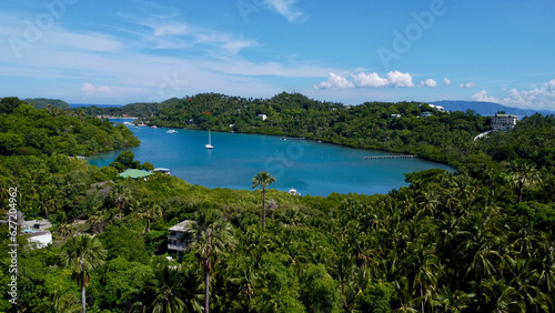 Tropical islands in the Pacific Ocean. Aerial view of the islands, beach and boats in the bay.