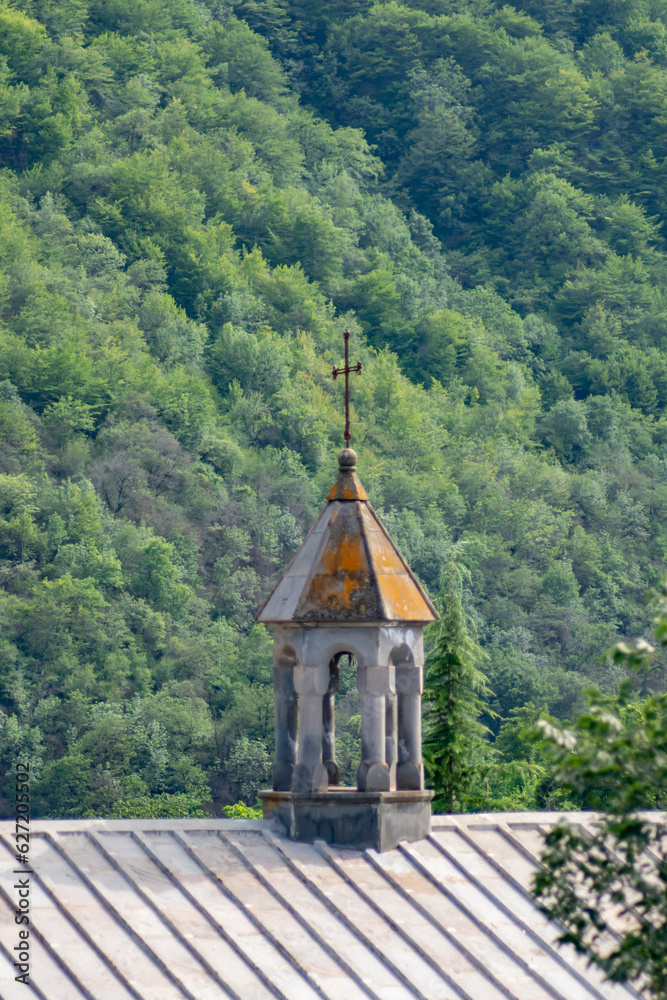 The dome of the church and the cross on the background of the forest The dome of the church and the cross on the background of the forest