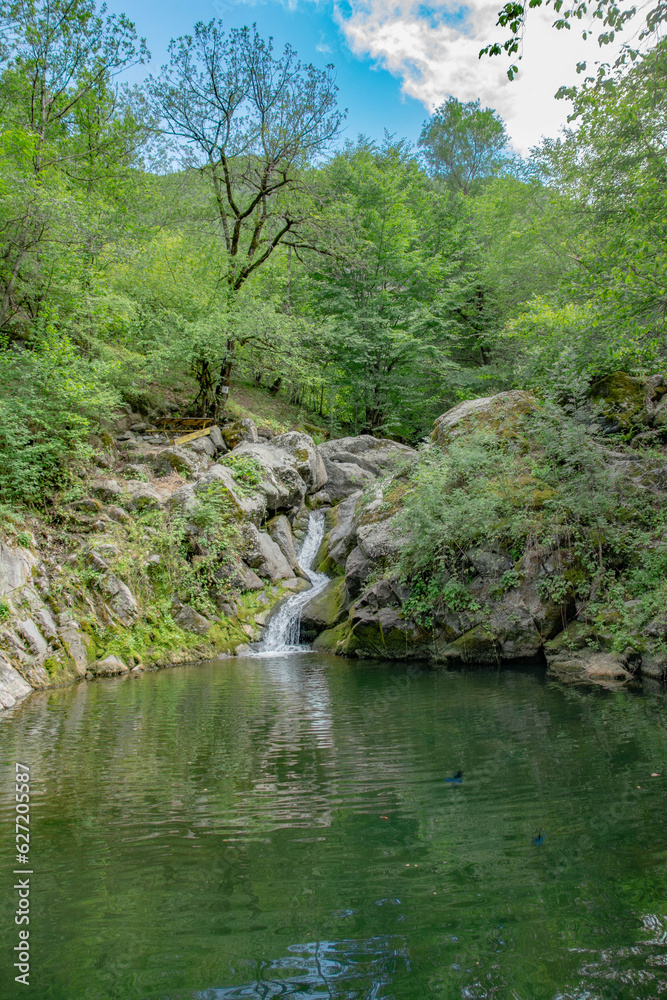 Small lake and waterfall. Beautiful waterfall in the forest Small lake and waterfall. Beautiful waterfall in the forest