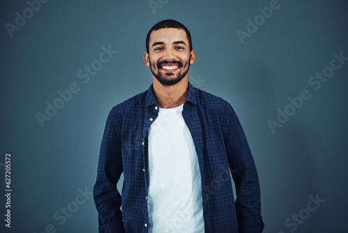 Be confident in who you are. Studio portrait of a confident man posing against a gray background.