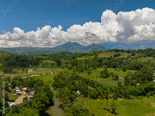 Top view of mountains with green forests and agricultural land with farm plantations. Mindanao, Philippines