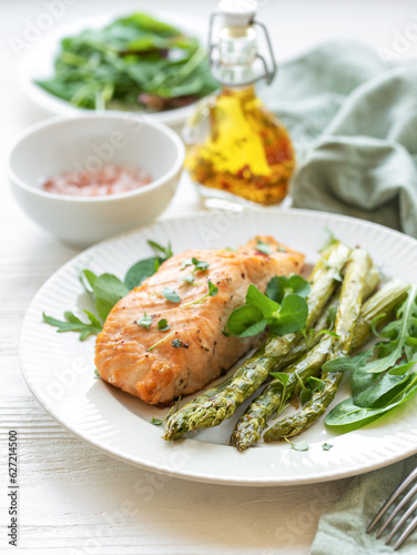 Fototapeta Naklejka Na Ścianę i Meble -  Baked Delicious salmon, green asparagus on  plate