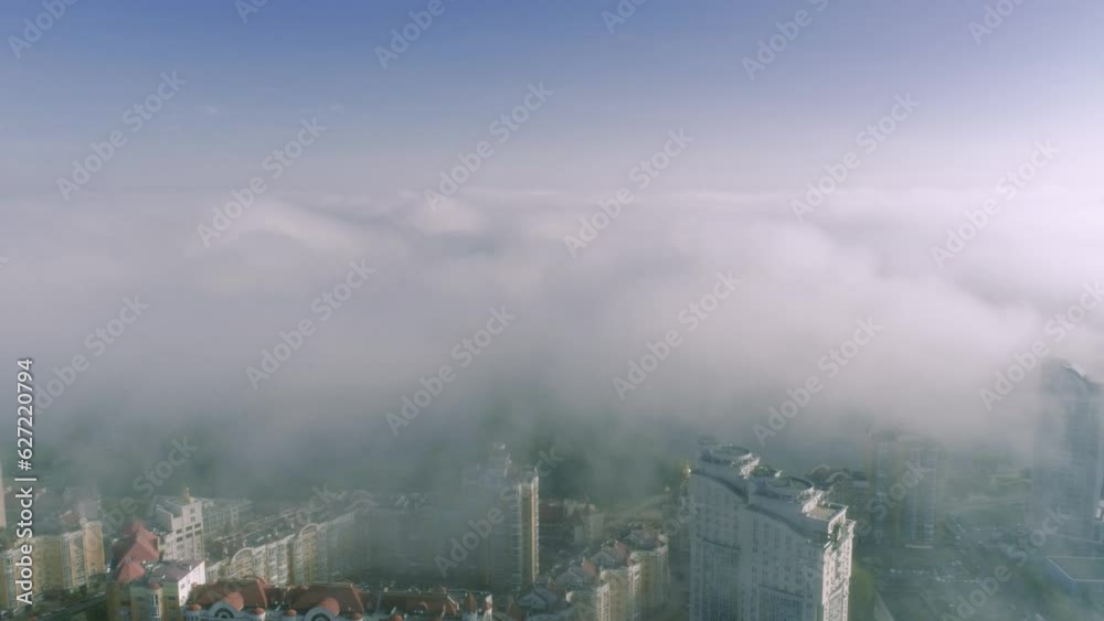 Aerial birds eye view of Kyiv city urban futuristic skyline during fog. Skylines under the thick fog around towers timelapse of Kyiv at morning Aerial birds eye view of Kyiv city urban futuristic skyline during fog. Skylines under the thick fog around towers timelapse of Kyiv at morning