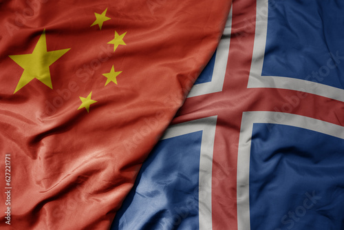 Photography big waving national colorful flag of china and national flag of iceland