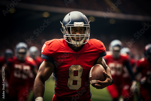 An American football player in a black helmet and red uniform walks with a ball in his left hand during a football match