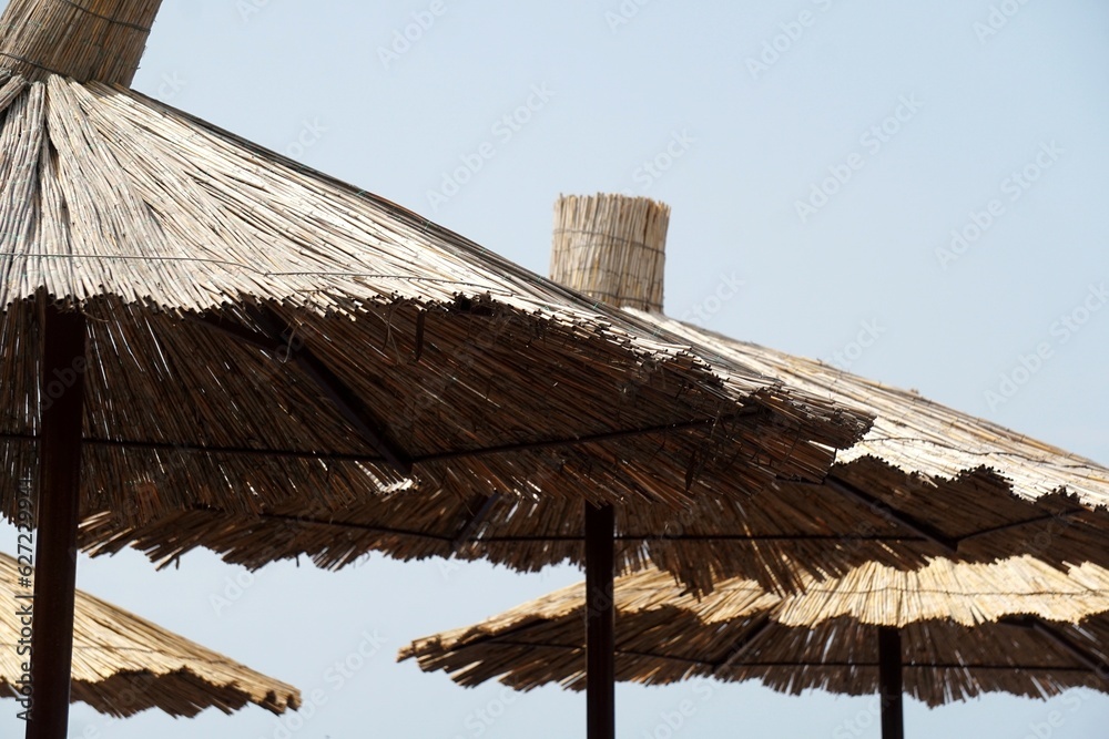 Straw beach umbrellas on the beach by the sea, Straw beach umbrella, Old Budva, Montenegro
Straw beach umbrellas on the beach by the sea, Straw beach umbrella, Old Budva, Montenegro