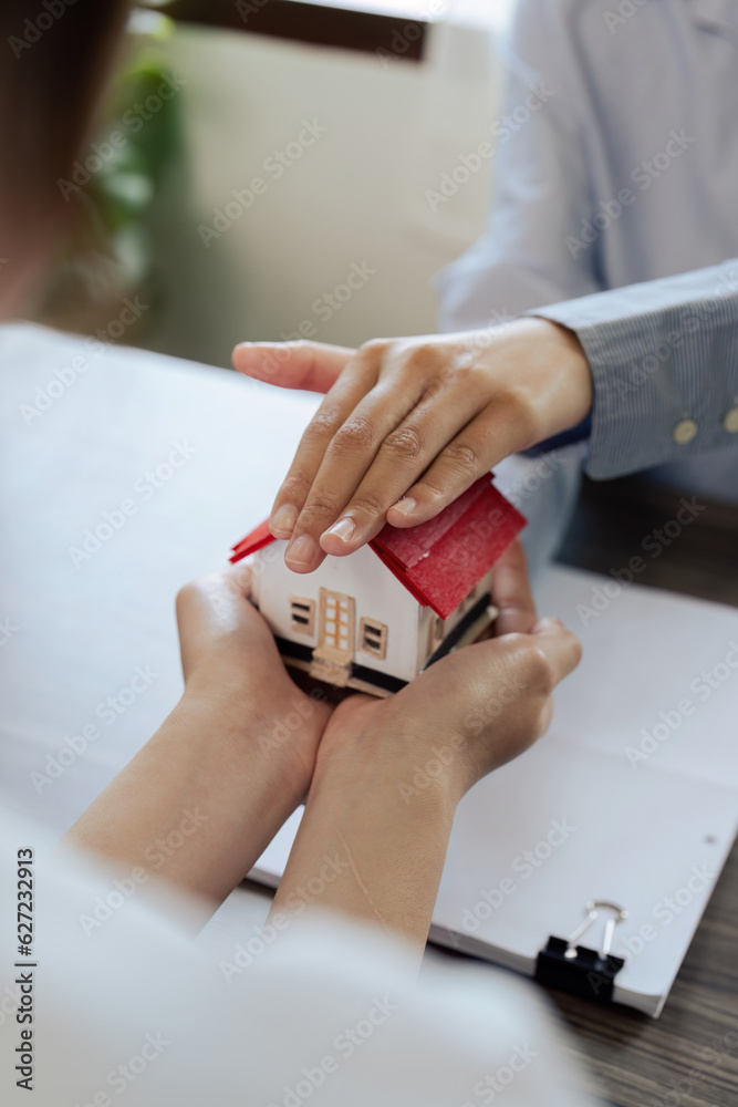 agent hand cover house model. real estate, insurance and property concepts after purchase agent hand cover house model. real estate, insurance and property concepts after purchase
