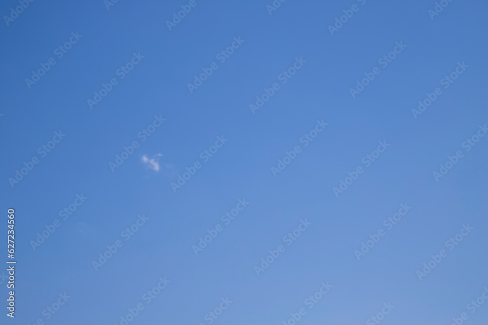 Clear blue sky. Against the background of a clear blue sky, one small cloud. Clear blue sky. Against the background of a clear blue sky, one small cloud.