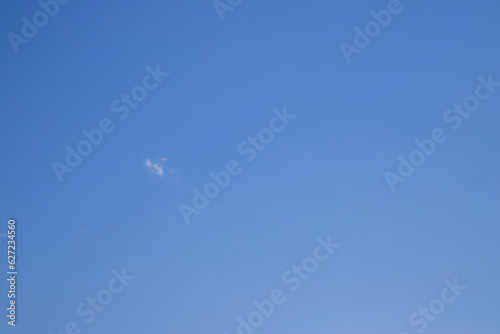 Against the background of a clear blue sky, one small cloud.