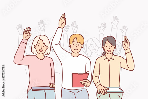 Group of people raise hands sitting in conference room and participating in business training