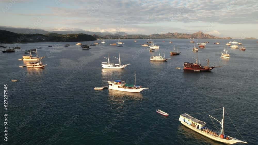 Labuan Bajo port - Rush Hour view in Labuan Bajo Harbour in the morning with Luxury Phinisi view Sailing Komodo National Park Labuan Bajo port - Rush Hour view in Labuan Bajo Harbour in the morning with Luxury Phinisi view Sailing Komodo National Park