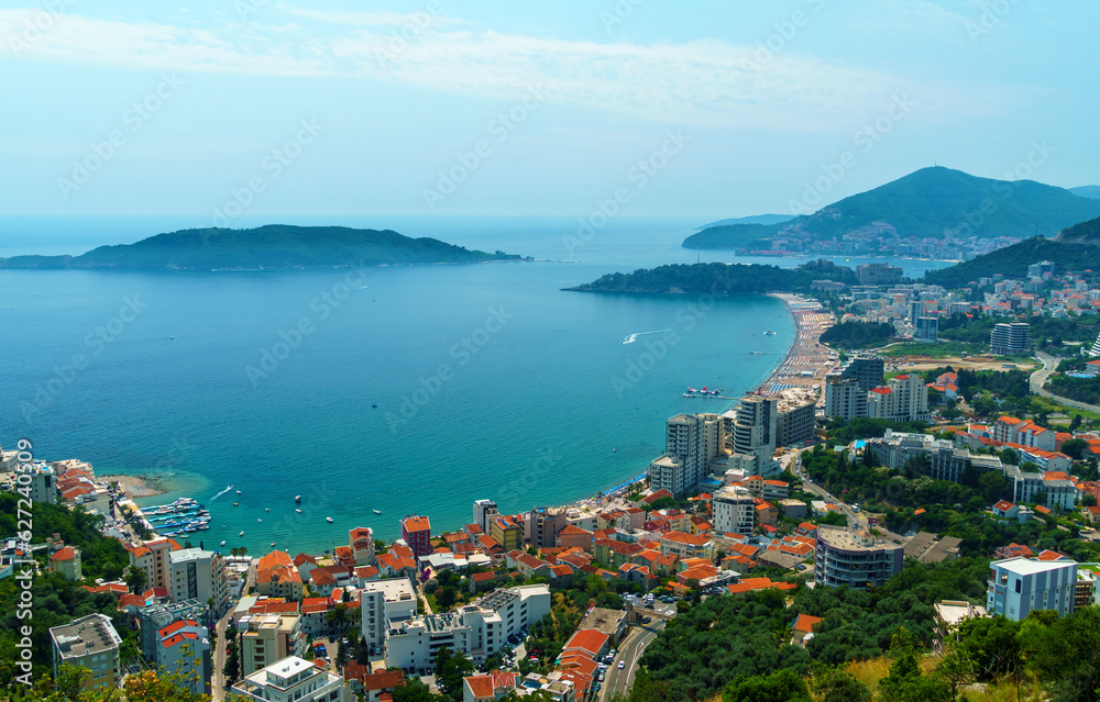 aerial view of the city on the seashore and mountains, panorama of the resorts of Becici and Budva in Montenegro, Adriatic sea, beaches, islands, tourism and travel, summer traveling