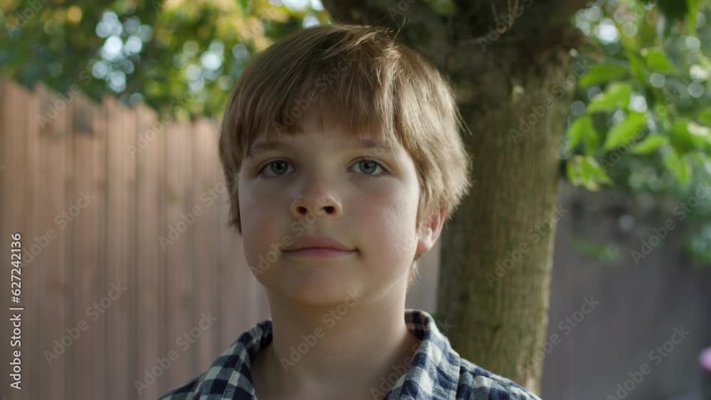 Boy Looking at Camera Outside. Kid's Portrait in Sunlight. Boy Looking at Camera Outside. Kid's Portrait in Sunlight.