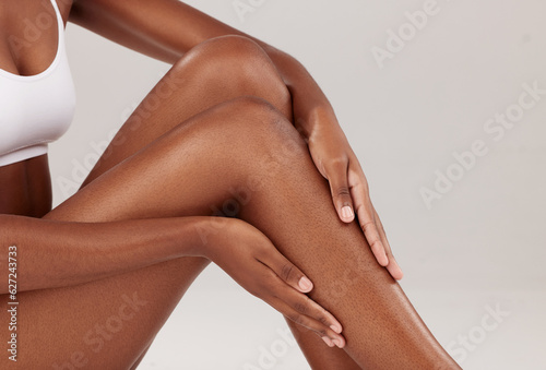 Studio, skincare or person touch legs to check epilation results, cosmetic hair removal and hygiene routine progress. Smooth skin, beauty salon waxing or closeup dermatology model on white background