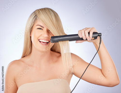 Portrait, happy hair care and woman with straightener for a professional salon treatment. Smile, health and an excited young model or girl with an iron from hairdresser for a hairstyle on a backdrop