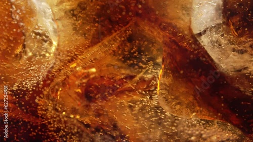 Bubbles and Ice Cubes in a Glass of Cola or Lemonade