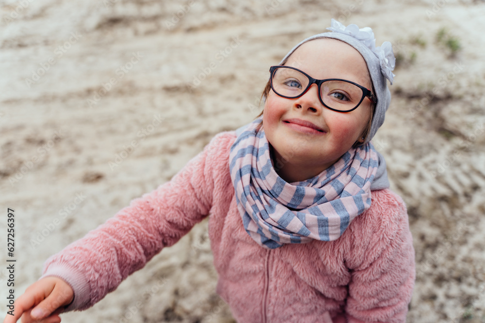 Authentic portrait of a little girl is happily walking in spring at nature outdoor. Little girl have fun. Authentic portrait of a little girl is happily walking in spring at nature outdoor. Little girl have fun.