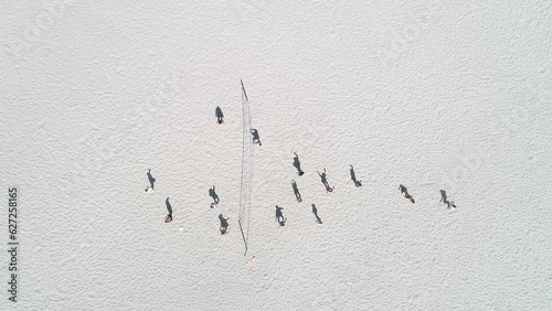 video with drone, aerial footage zenithal view of people playing beach volleyball