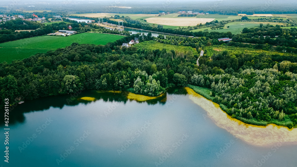 Aerial drone view of lake among forest, Nordrhein westfalen, Germany in summer day. 
