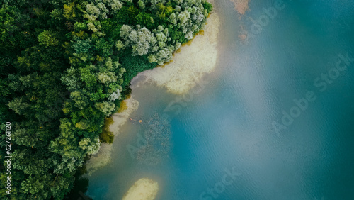 Aerial drone top down view of lake among forest, Nordrhein westfalen, Germany in summer day. 