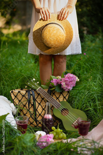 A girl on a picnic on a green meadow