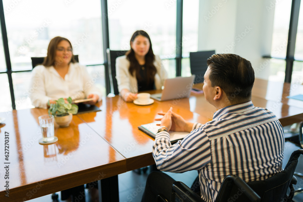 Disabled person giving job interview at office Disabled person giving job interview at office