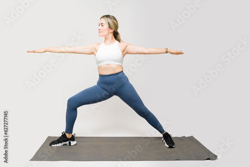 Attractive athletic woman exercising with yoga