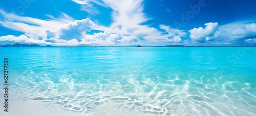 A tropical ocean scene with sand, sun with blue sky. Paradise island concept. © Adrian Grosu