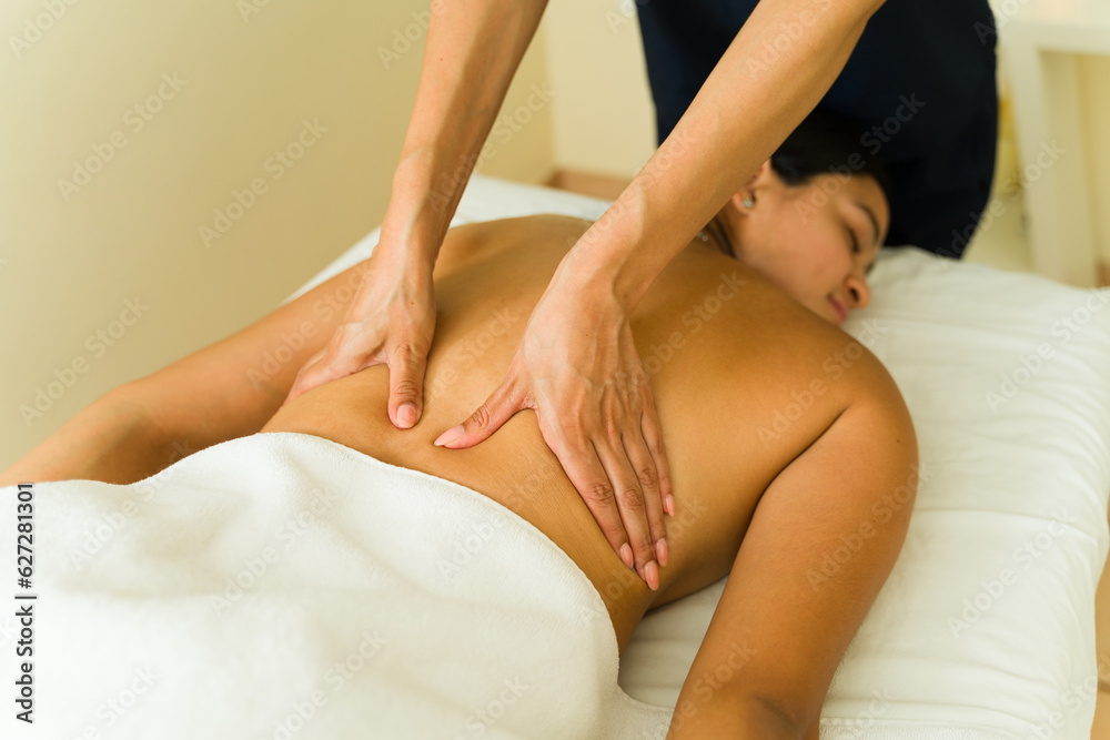 Gorgeous hispanic woman lying at the massage table Gorgeous hispanic woman lying at the massage table