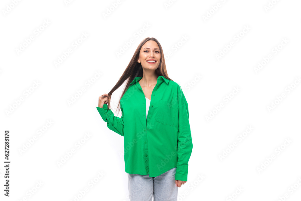 smiling happy young european female model with well-groomed black hair and make-up dressed in a green shirt on a white background with copy space smiling happy young european female model with well-groomed black hair and make-up dressed in a green shirt on a white background with copy space