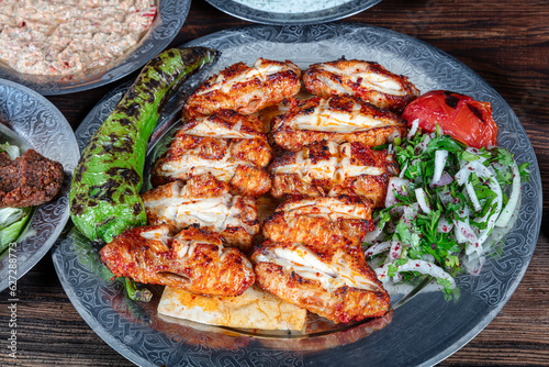 Turkish cuisine chicken wings grill. Chicken wings, chicken kebab with grilled vegetables.
