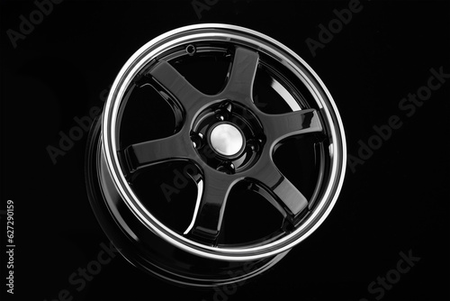 Stylish black die-cast disc for sports design cars on a black background.