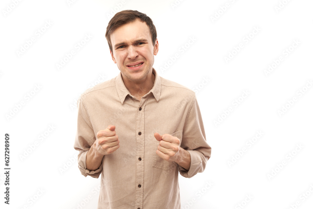 Portrait angry brunette young male screaming isolated on white studio background, showing negative emotions Portrait angry brunette young male screaming isolated on white studio background, showing negative emotions