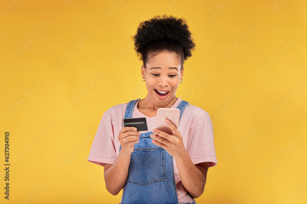 Woman, credit card and surprise with phone, studio and shock face for deal, discount or sales by yellow background. Gen z girl, cell phone and banking with wow for investment, smile and fintech app Woman, credit card and surprise with phone, studio and shock face for deal, discount or sales by yellow background. Gen z girl, cell phone and banking with wow for investment, smile and fintech app