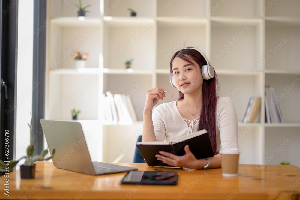 University girl student studying online lesson at public workspace, Remote online video for educational learning, Research information from the video. University girl student studying online lesson at public workspace, Remote online video for educational learning, Research information from the video.
