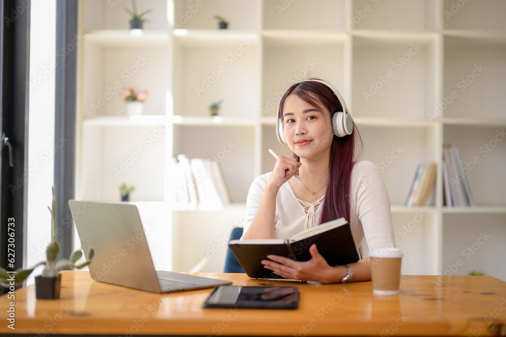 University girl student studying online lesson at public workspace, Remote online video for educational learning, Research information from the video. University girl student studying online lesson at public workspace, Remote online video for educational learning, Research information from the video.