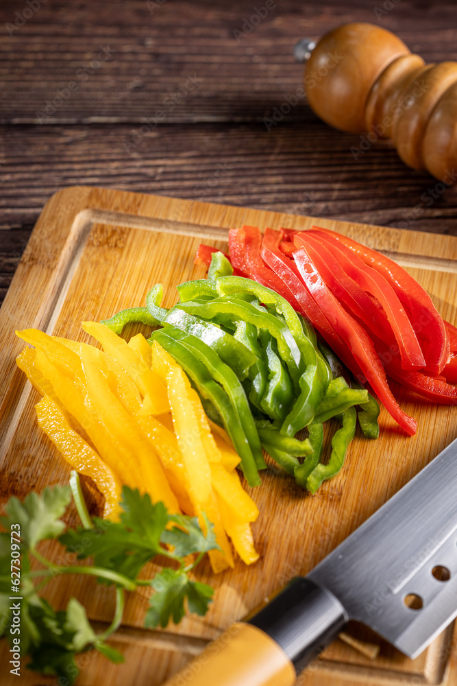 Colorful bell peppers sliced on cutting board. Colorful bell peppers sliced on cutting board.