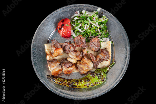 Turkish cuisine Meat skewers. Barbecue skewers with juicy meat on metal plate. Shish kebab barbecue meat with onions and tomatoes.