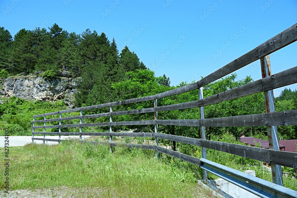 Wooden fence over the bridge over the river Wooden fence over the bridge over the river