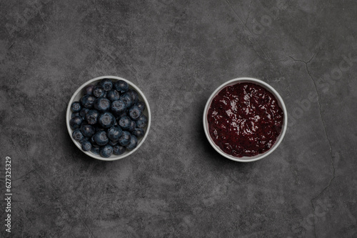 Blueberries and marmalade in white bowls