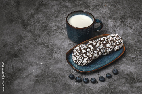 Chocolate crinkle cookies with blueberries and glas of milk 