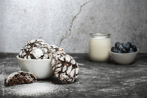 Chocolate crinkle cookies with blueberries and glas of milk