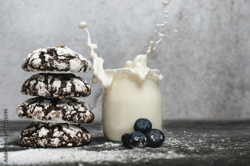 Chocolate crinkle cookies with blueberries and glas of milk