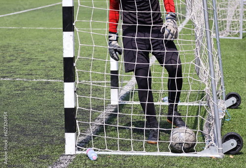 Ball in the goal with goalkeeper photo