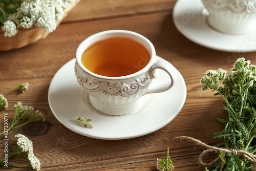 A cup of herbal tea with fresh yarrow - medicinal plant