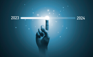 Hand touching on download bar status to change from 2023 to 2024  for countdown of merry Christmas and happy new year by technology concept, Start new business and new life.